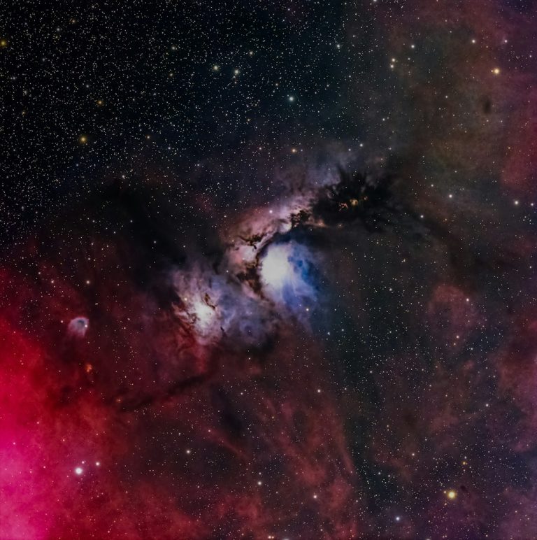 Nebula filled with vibrant colors and stars in a cosmic background.