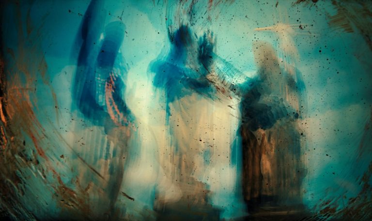 Silhouettes of three figures in an abstract, dreamlike setting with blue and gold hues.